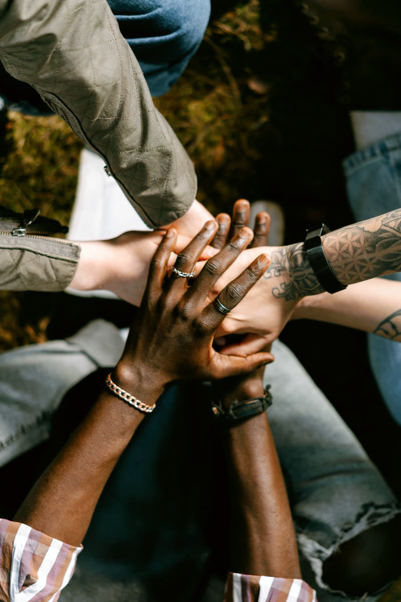 A group placing their hands together in unity
