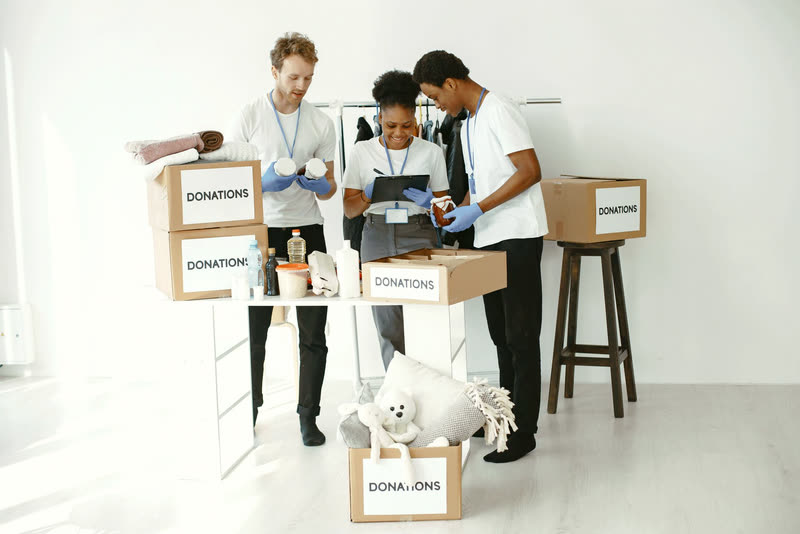Volunteers organizing donation boxes together