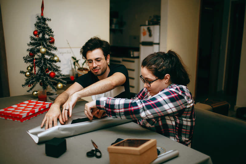 A couple wrapping presents together