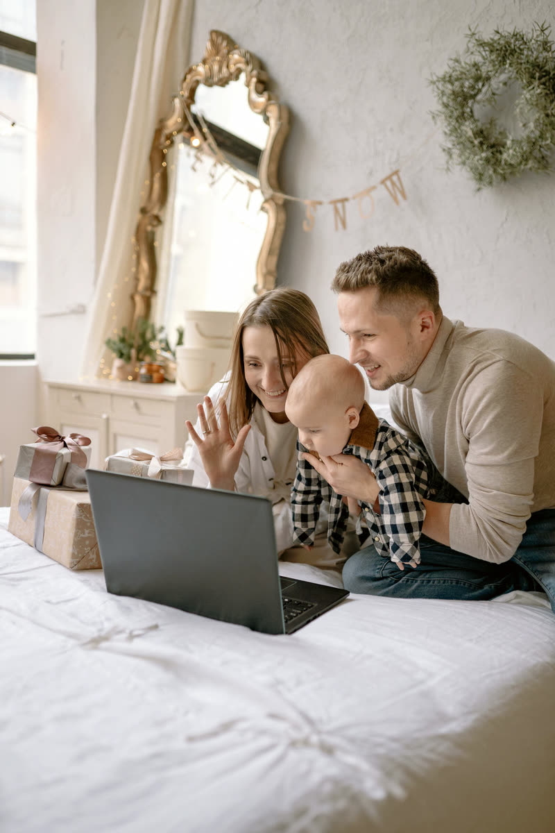 A family together with gifts on a video call