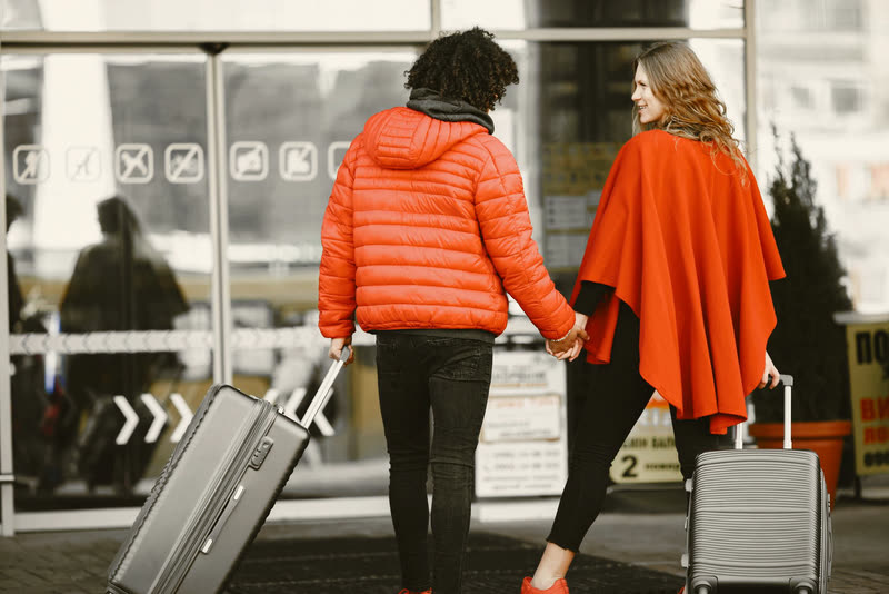 A couple heading off on their honeymoon with luggage